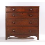 George III oak chest of four long drawers, with turned handles, on a shaped apron and bracket