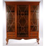 Early 20th Century mahogany glazed bookcase, the concave cornice above three astragal glazed doors