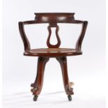 Early 20th Century swivel desk chair, with an arched back above sweeping arms and solid seats