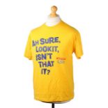 Ed Sheeran's t-shirt, Fruit of the Loom, in yellow with the text 'AH SURE, LOOK IT, ISN'T THAT IT,