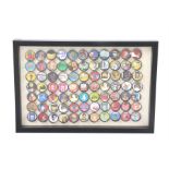 Ed Sheeran's bottle cap collection, housed within a frame with cut papers to the centre of each,