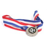 Ed Sheeran's football medal, the metal medal with a football attached to the red, white and blue