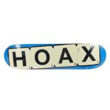 Ed Sheeran's Hoax skateboard board, natural wood top with Hoax underneath with blue edge. All of the