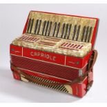 Capriole piano accordion, the red and black body with mother of pearl effect keys, housed in a