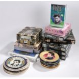 A collection of 16 decorative plates depicting Elvis through the years, plus 9 jigsaws, a clock