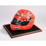 Michael Schumacher replica helmet, signed to the visor, housed in a display cabinet, with