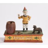 Painted iron "Trick Dog" money box, 21 cm wide