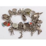 Silver charm bracelet, with various charms, some enamel examples