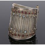 Walter Gilbert (B1946), silver cuff bracelet, set with moonstones and garnets, the central band with