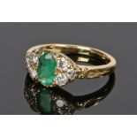 18 carat gold emerald and diamond set ring, the emerald flanked by three diamonds to either side,