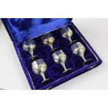 A boxed set of six silver plated saki cups