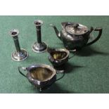 Silver plated three piece tea service, together with a pair of candlesticks, (5)