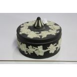 Wedgwood black basalt pot and cover, with white fruiring vine decoration