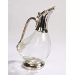 Plate mounted glass claret jug, with loop handle and clear glass body raised on a plated circular