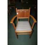 Oak armchair, with a Gothic style back above a drop I seat and curved arms