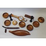 Turned wooden bowls, together with wooden candlesticks, canoe, barometer , and a glass oil lamp,