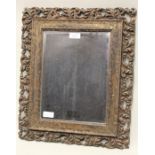 bevelled wall mirror, housed in an acanthus scroll decorated pierced gilt frame, 37.5cm x 44.5cm