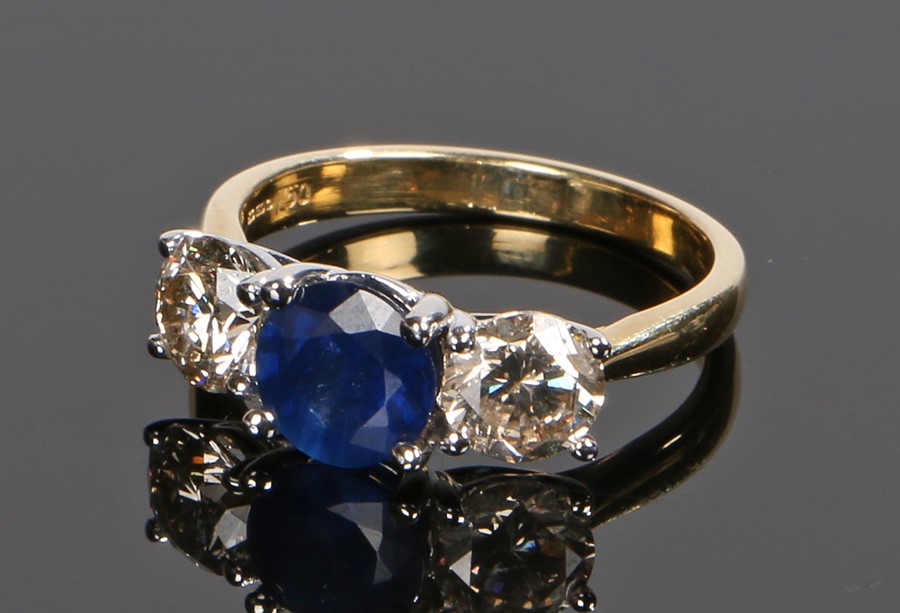 18 carat gold diamond and sapphire set ring, the central sapphire at approximately 1.41 carat