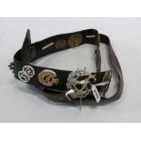 2 BELTS WITH MILITARY BADGES ETC