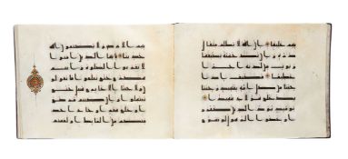 Ɵ A Juz' from a Kufic-style Qur'an, in Arabic, illuminated manuscript on parchment