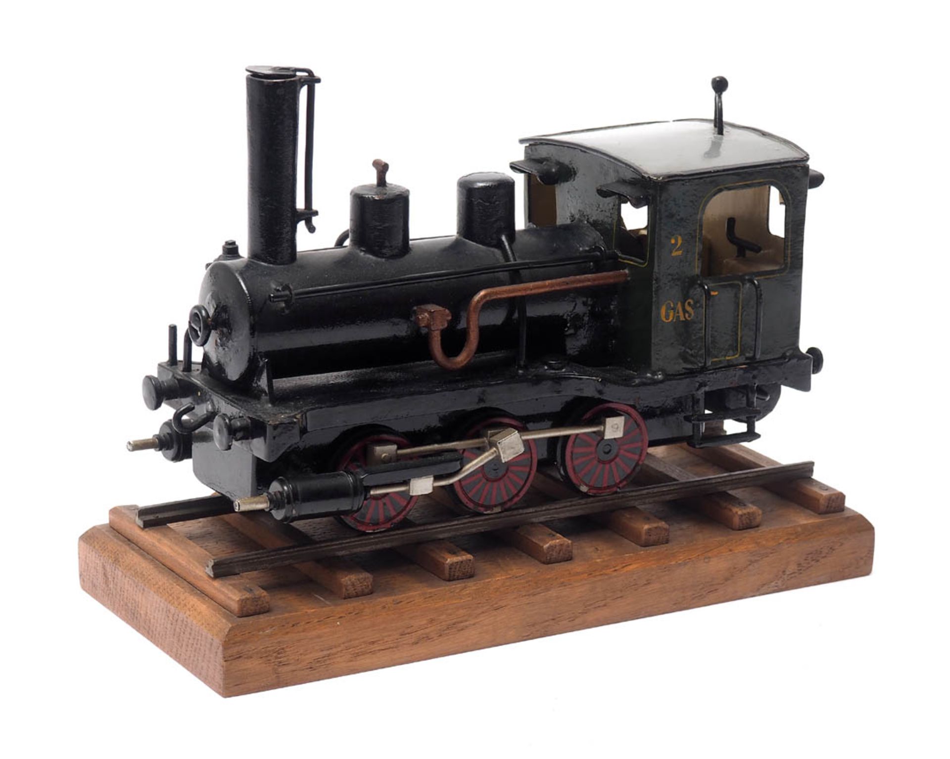 Modell einer Dampflokomotive Metall, farbig lackiert, auf Schienenstück stehend. L.25cm.