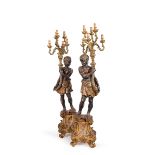 A pair of gilt and lacquered flambeaux