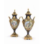 A pair of French blue, gilt and polychrome porcelain potiches