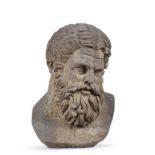 A stone head of a bearded man