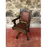 Antique swivel arm chair with leather and stud upholstery