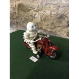 Cast metal Michelin man on motorcycle