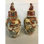 A pair of oriental hand painted temple jars with fitted lids