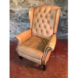Cream leather button back gull wing, chesterfield reclining chair.
