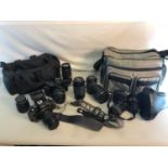 2 Carry cases filled with various cameras and lenses to include Canon, Praktica & Minolta etc