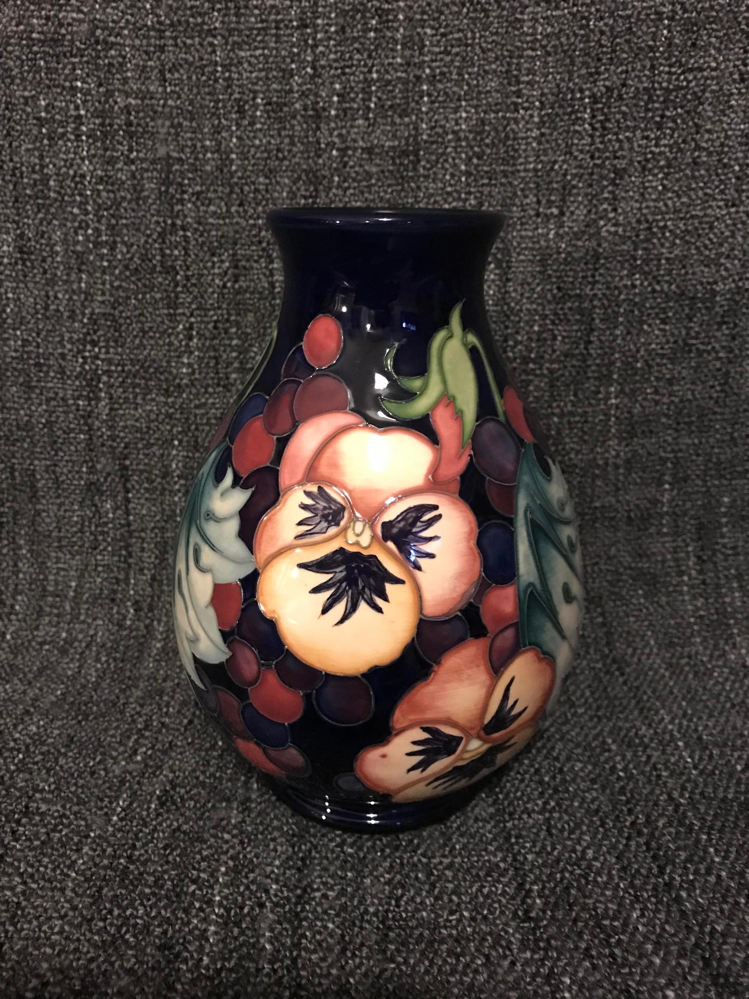 Moorcroft Pansy design vase, signed to the base, 19cm in height.