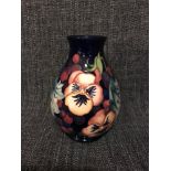 Moorcroft Pansy design vase, signed to the base, 19cm in height.