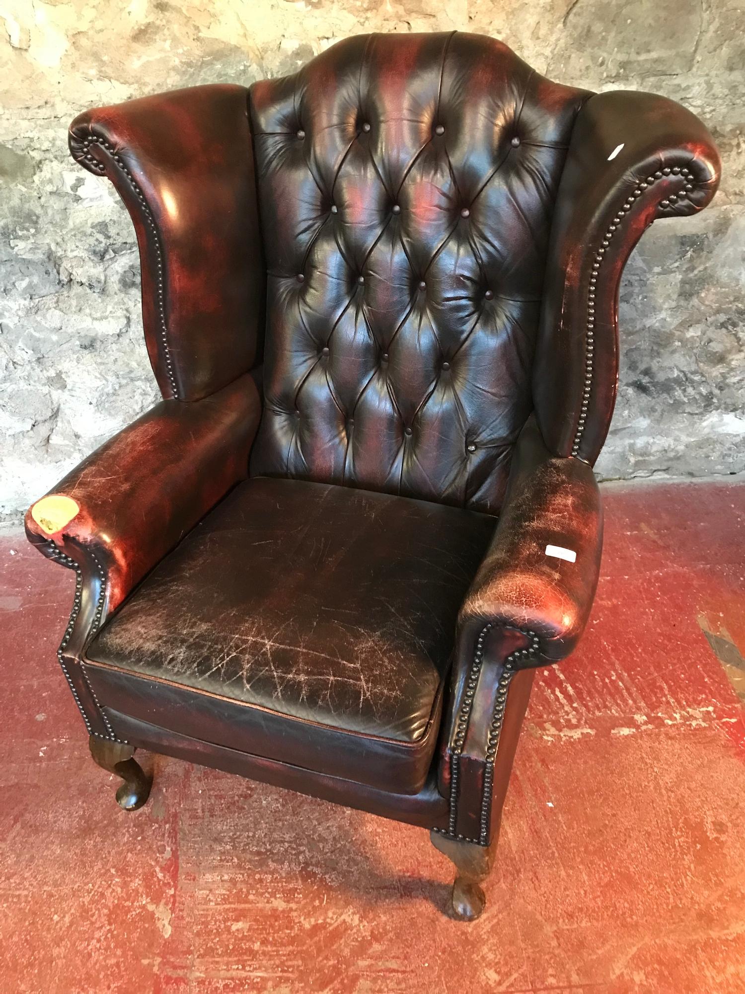 Ox blood red chesterfield gull wing chair.Left arm needs attention. As seen in the photographs