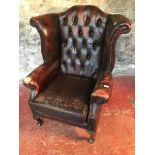 Ox blood red chesterfield gull wing chair.Left arm needs attention. As seen in the photographs