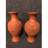 A Pair of early 1900's Chinese dragon design vases done in terracotta. measure 31cm in height.