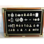 A collection of military badges framed and displayed.