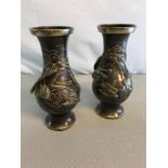 A Pair of early 1900's bronze vases depicting raised phoenix chasing another bird. Measure 18.5cm in