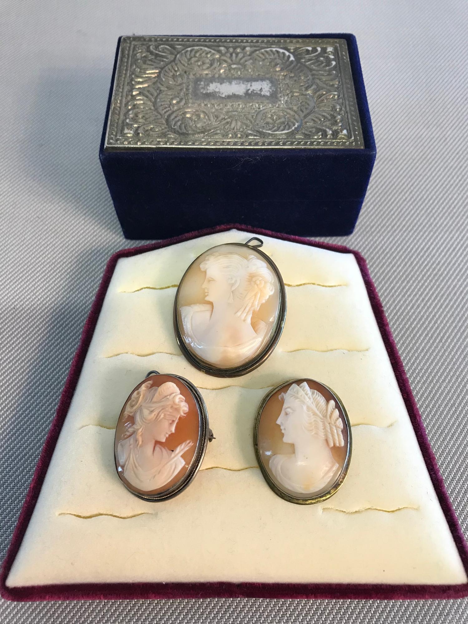 3 Various Vintage cameo brooches. One is 800 grade silver and the others are yellow metal.