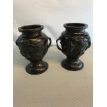 A Pair of early 1900's Bronze urns both depicting bird & Foliage designs. Measure 15cm in height.