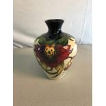 Moorcroft Vase in the Anna Lily design. Stands 18cm in height. Red dot Underneath