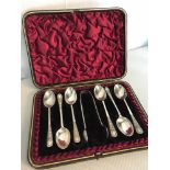 Birmingham silver 6 spoon set with matching tongs all with ornate trims within a fitted red velvet