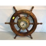 Nautical ships wheel done in solid wood and brass, with centre clock piece (Battery). Measures