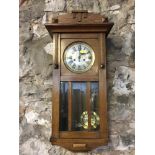 Art Deco Oak cased wall clock with key and pendulum