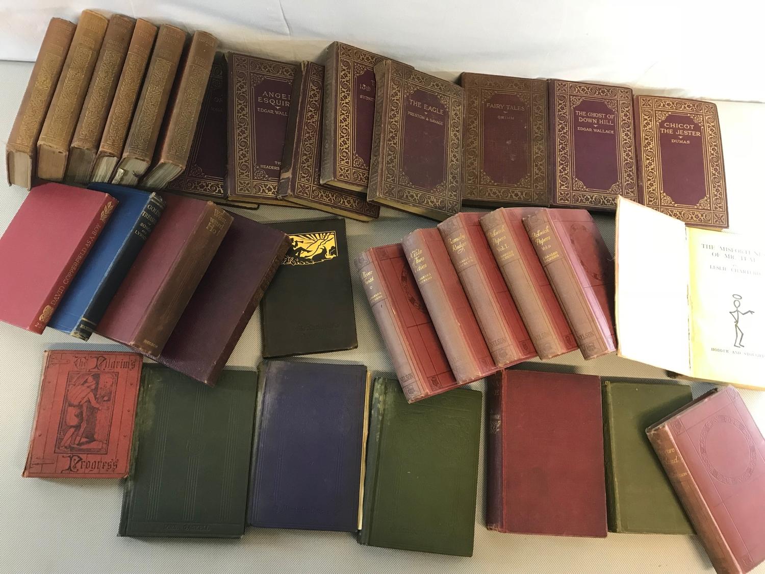 A Collection of old books to include Charles Dickens, Treasure Island, Leslie Charters etc