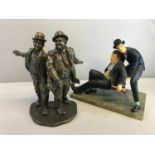 Bronze effect Laurel and Hardy figures together with another Laurel and Harry figure