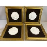 A Set of 4 Royal Copenhagen White Basalt Plaques framed on Brown velvet and gilt backings.