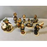 A Collection of Hummel boy and girl figures some are damaged